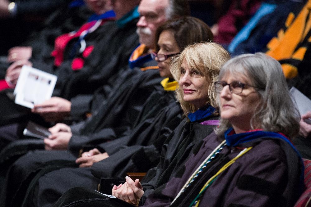 Faculty listen intently to speaker during ceremony